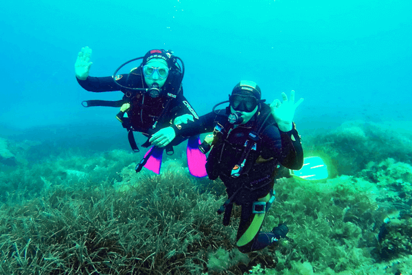 A Couple Enjoying Scuba Diving In Greece