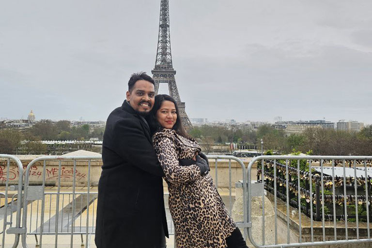 Family Taking Photos Behind Eiffel Tower