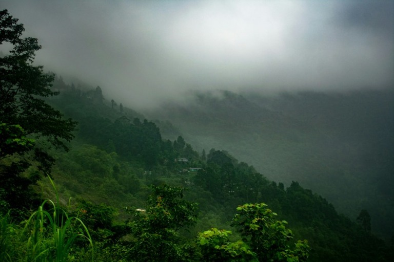 A mountain landscape with lush green hills.