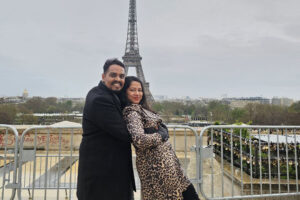 Family Taking Photos Behind Eiffel Tower